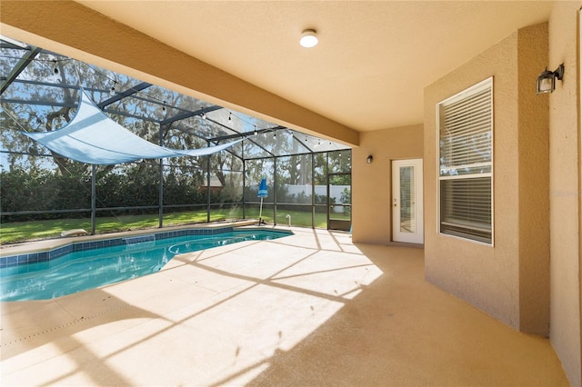 view of swimming pool featuring a patio area and a lanai