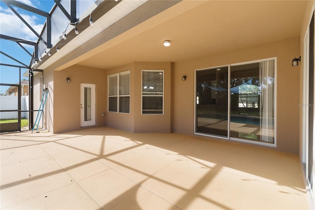 view of patio featuring a lanai