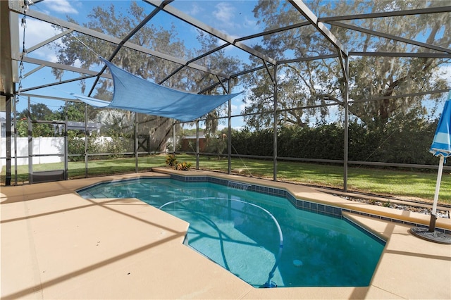 view of pool featuring glass enclosure, a lawn, and a patio