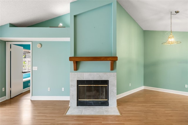 unfurnished living room featuring a fireplace, light hardwood / wood-style flooring, and a textured ceiling