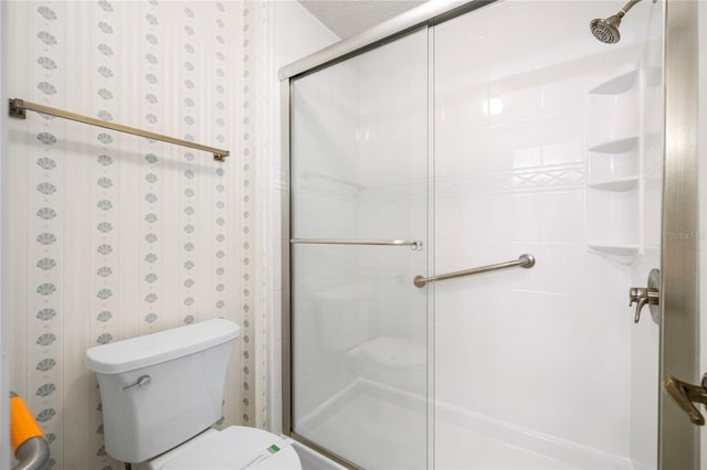 bathroom featuring toilet and an enclosed shower