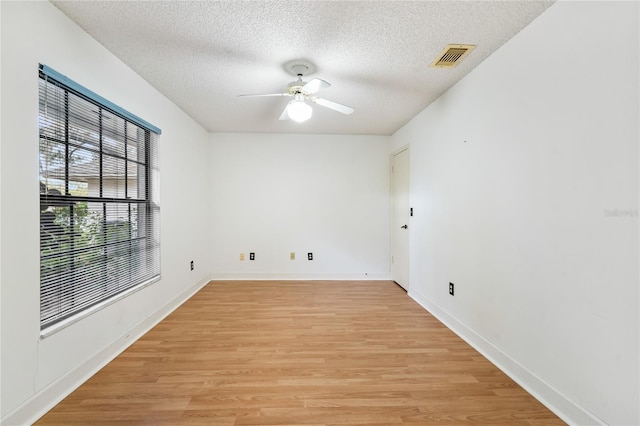 interior space with a textured ceiling, light hardwood / wood-style flooring, and ceiling fan