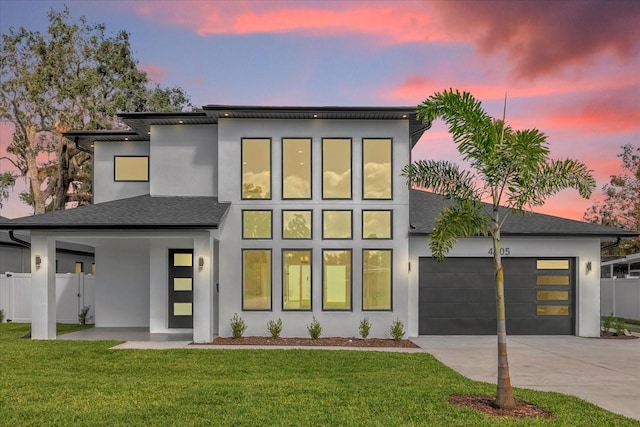 view of front of home featuring a yard and a garage