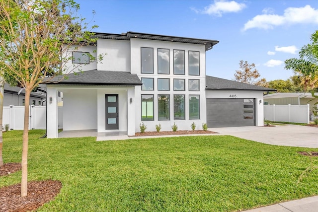 modern home with a front lawn and a garage