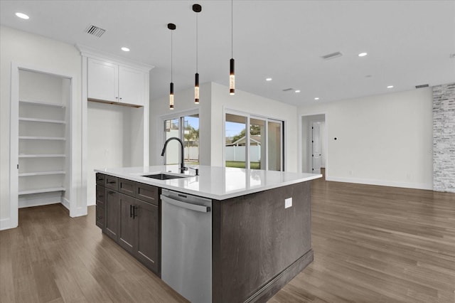 kitchen featuring white cabinetry, hanging light fixtures, an island with sink, dishwasher, and dark hardwood / wood-style floors