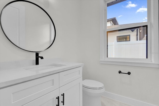 bathroom featuring vanity and toilet