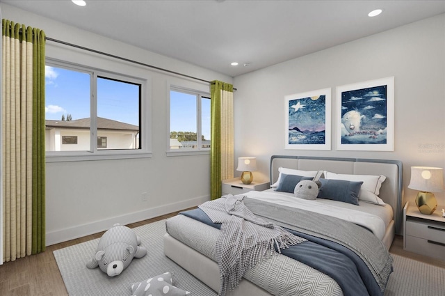 bedroom featuring hardwood / wood-style floors and multiple windows