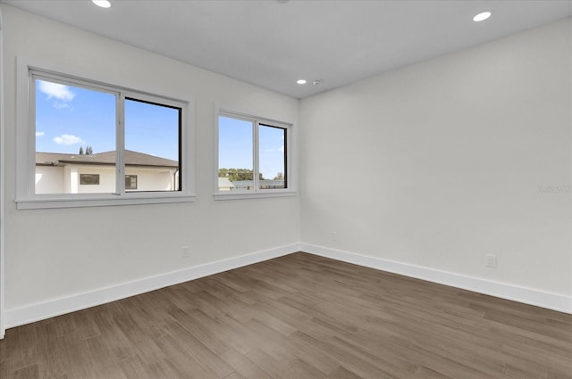 unfurnished room with hardwood / wood-style flooring