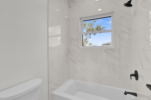 bathroom featuring toilet and tiled shower / bath combo