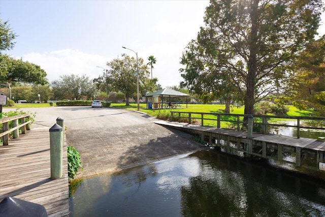 view of dock featuring a gazebo and a water view