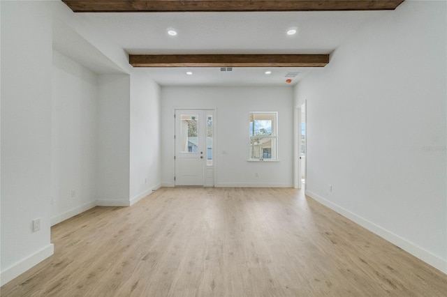 interior space with light hardwood / wood-style flooring and beamed ceiling