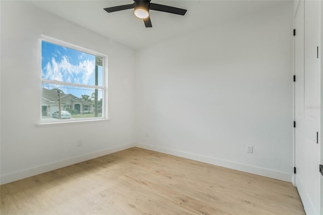 empty room with ceiling fan and light wood-type flooring