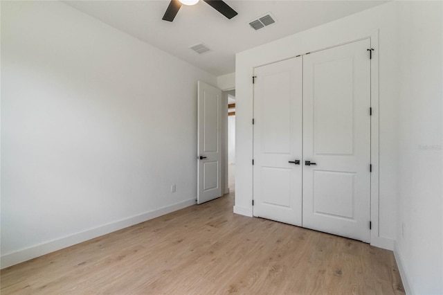 unfurnished bedroom with light wood-type flooring, a closet, and ceiling fan