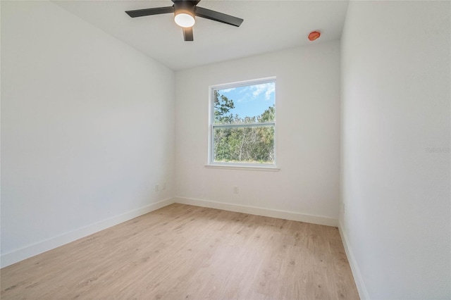 empty room with ceiling fan and light hardwood / wood-style floors