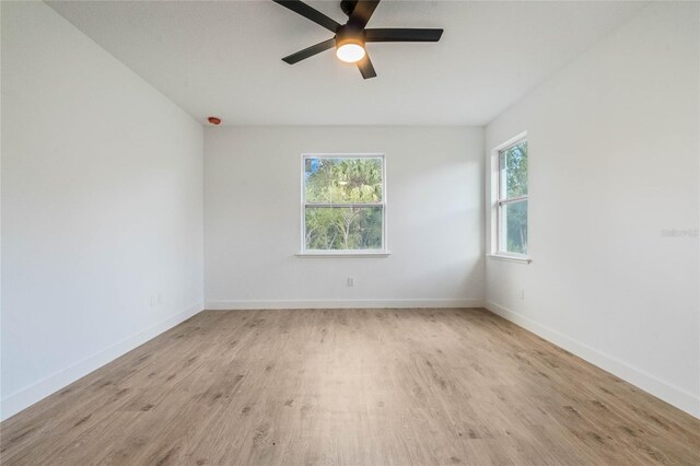 empty room featuring light hardwood / wood-style flooring and ceiling fan