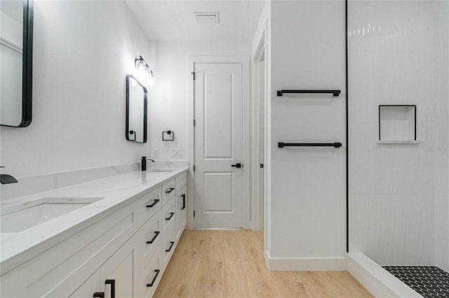 bathroom with vanity and hardwood / wood-style flooring