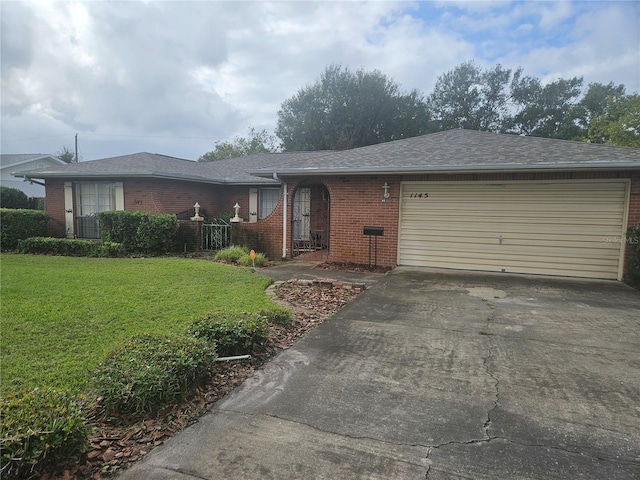 single story home featuring a garage and a front yard