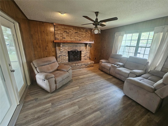 living room featuring hardwood / wood-style floors, a fireplace, and a textured ceiling