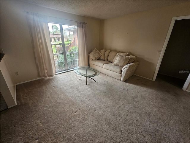 unfurnished living room with carpet floors and a textured ceiling