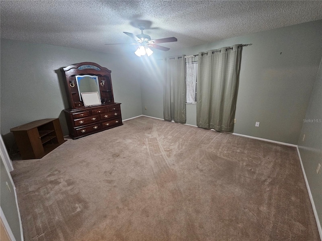 unfurnished bedroom featuring a textured ceiling, carpet flooring, and ceiling fan