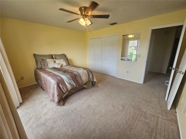 bedroom with a closet, light colored carpet, and ceiling fan