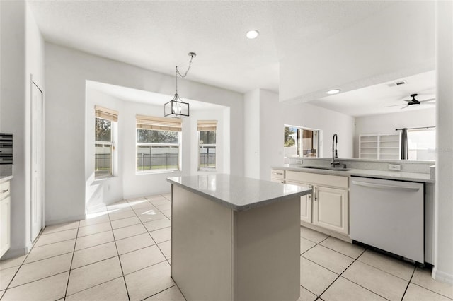 kitchen with white cabinetry, sink, white dishwasher, pendant lighting, and a kitchen island