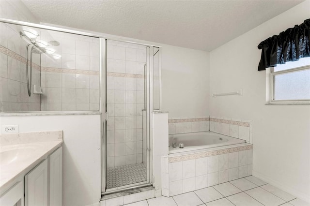 bathroom with tile patterned flooring, vanity, a textured ceiling, and shower with separate bathtub