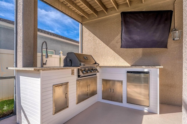 view of patio featuring sink, area for grilling, and exterior kitchen