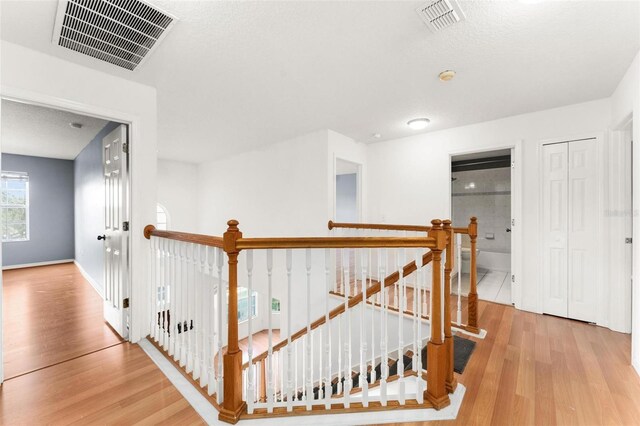 corridor with light hardwood / wood-style floors