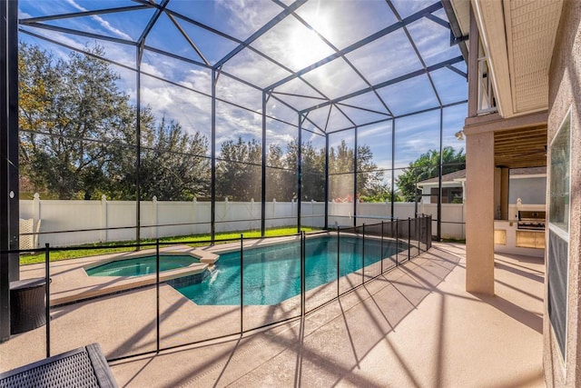 view of pool with a lanai, an in ground hot tub, a patio, and an outdoor kitchen