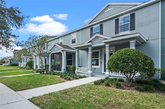 view of front of house featuring a porch and a front lawn