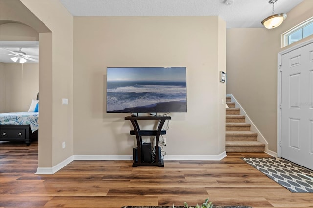 entryway featuring ceiling fan, a textured ceiling, and hardwood / wood-style flooring