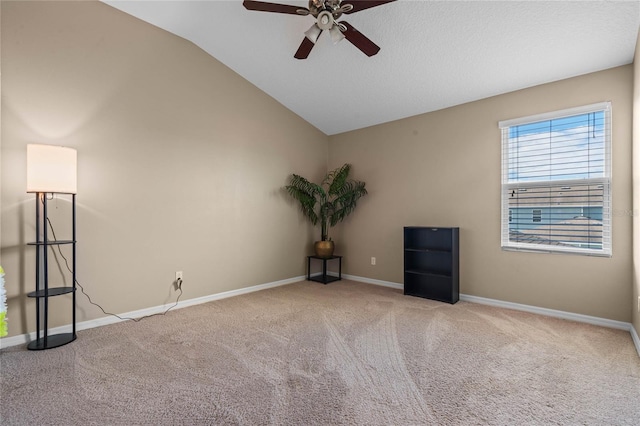 carpeted empty room with vaulted ceiling and ceiling fan