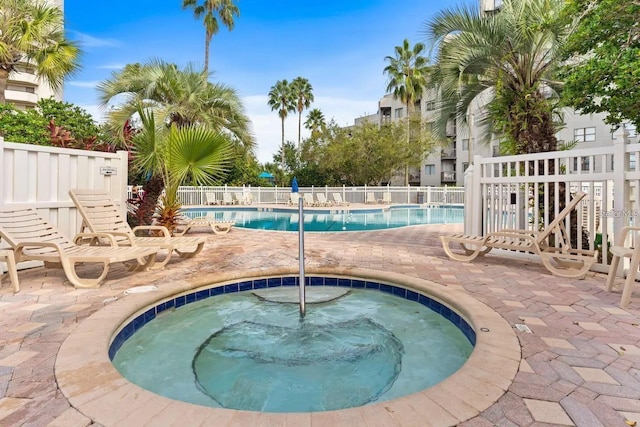 view of pool with a community hot tub