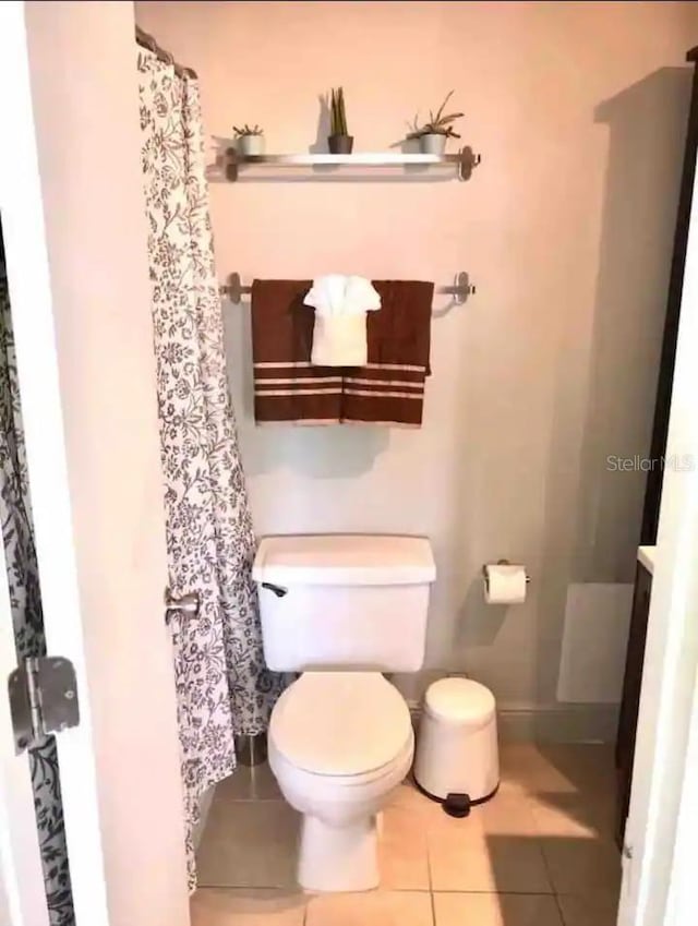 bathroom featuring tile patterned floors and toilet