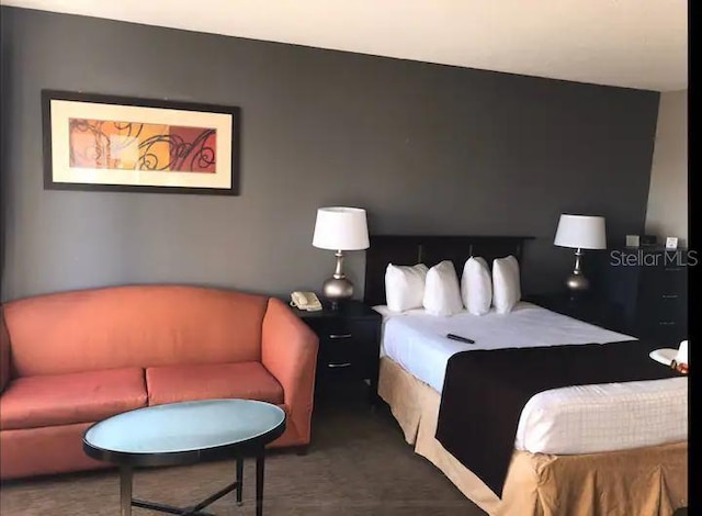 bedroom featuring dark colored carpet