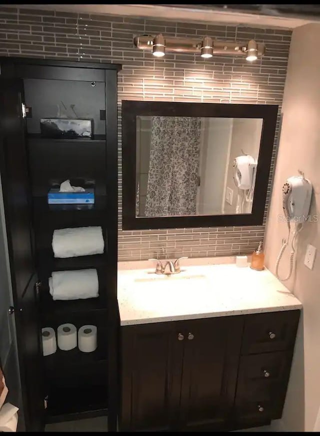 bathroom featuring tasteful backsplash and vanity