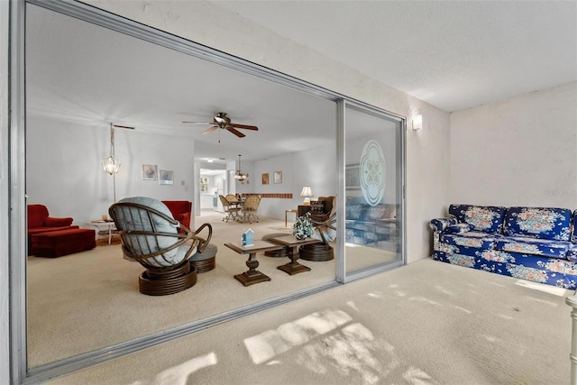 carpeted living room with ceiling fan