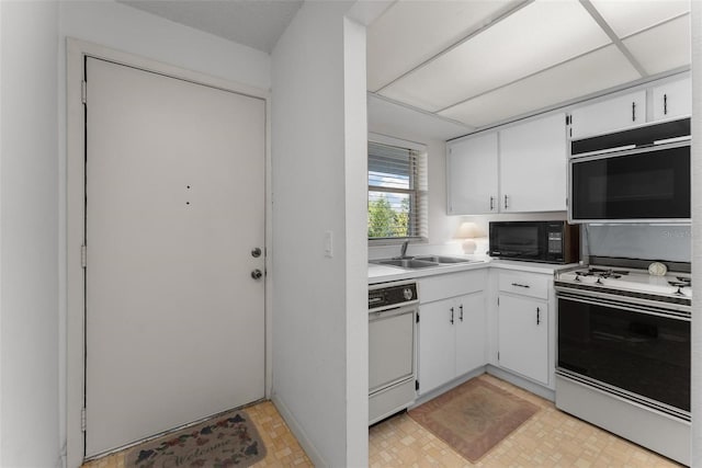 kitchen featuring white appliances, sink, and white cabinets