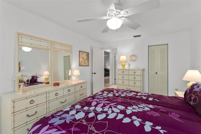 bedroom with a closet, a textured ceiling, and ceiling fan