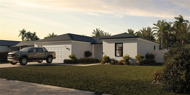 view of front facade featuring a lawn and a garage