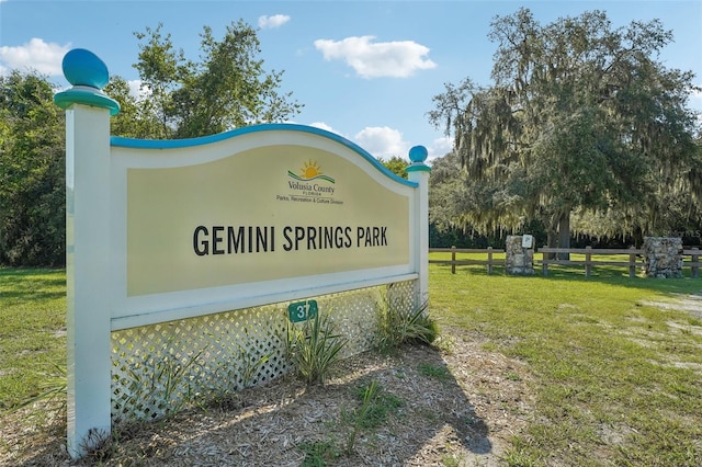 community sign featuring a lawn