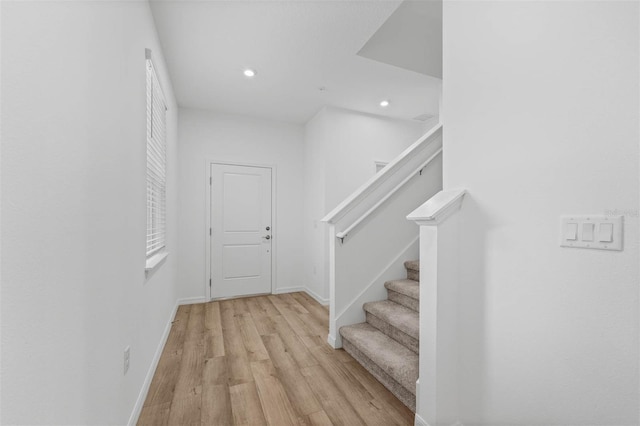 stairs with hardwood / wood-style flooring