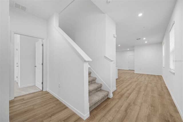 stairway with hardwood / wood-style flooring