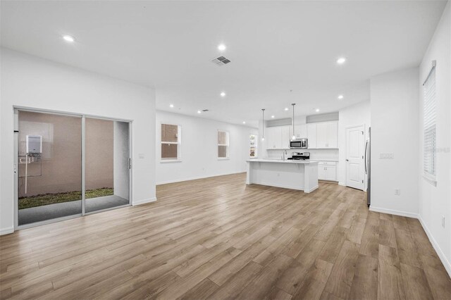 unfurnished living room featuring light wood-type flooring