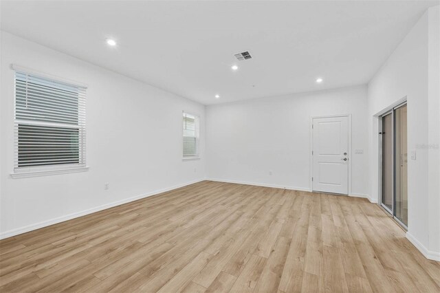 unfurnished room with light hardwood / wood-style floors