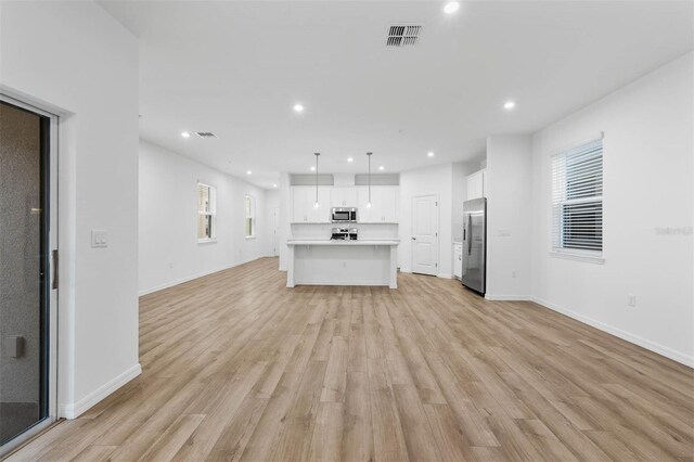 unfurnished living room featuring light hardwood / wood-style floors