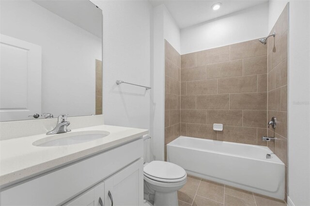 full bathroom with vanity, tile patterned floors, toilet, and tiled shower / bath