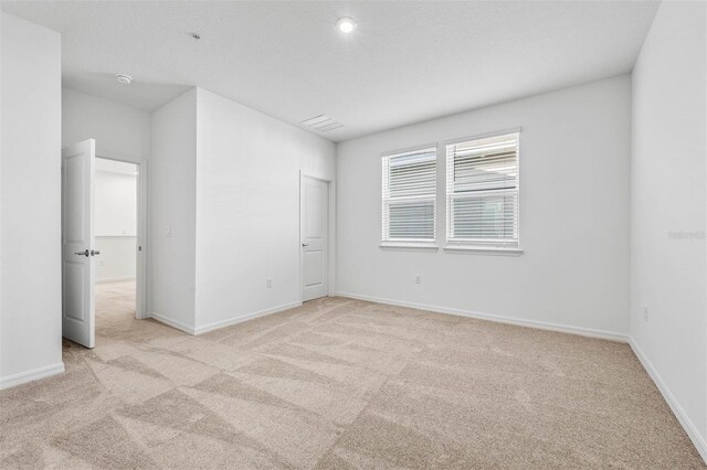 unfurnished bedroom with light colored carpet