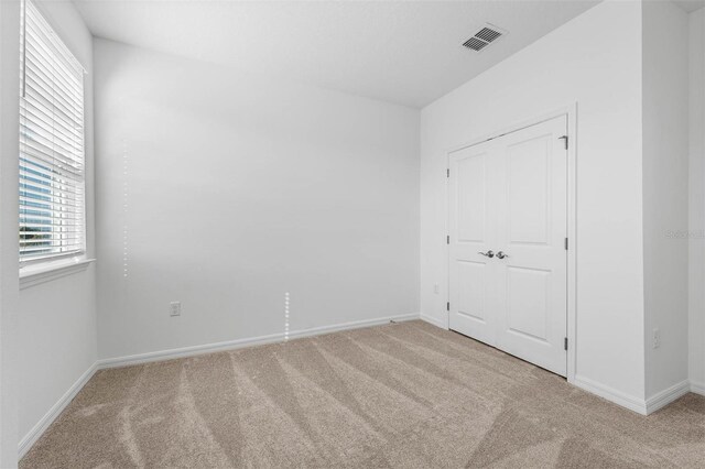 unfurnished bedroom with light carpet